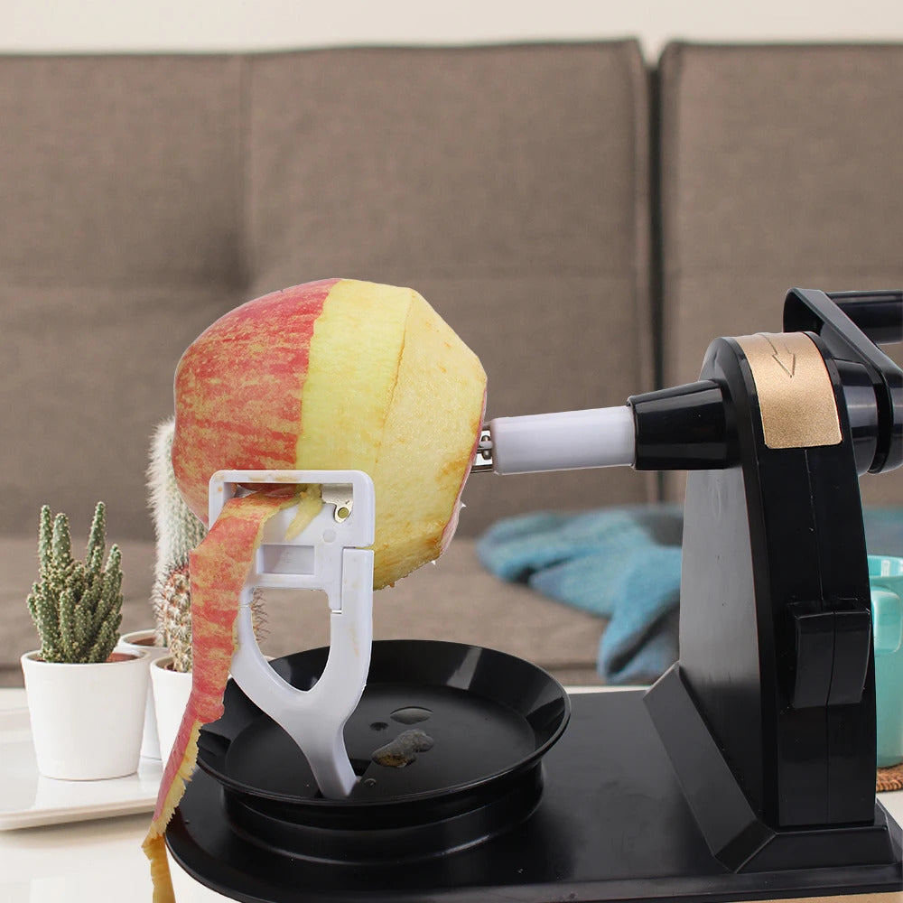 Apple being peeled on a hand crank fruit and vegetable peeling machine.