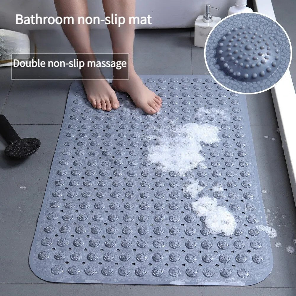 Feet standing on gray non-slip bath mat with soap foam