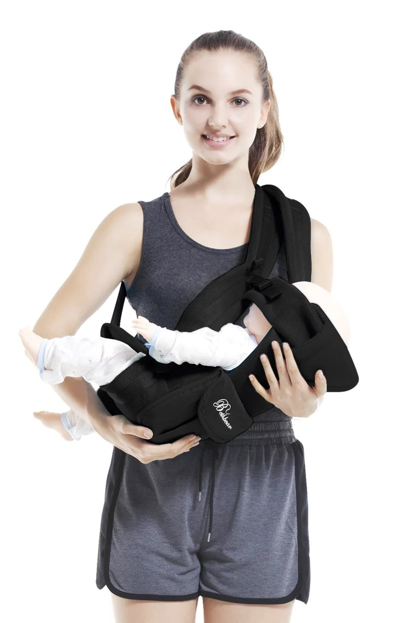 Black 4-in-1 breathable baby carrier with infant in a horizontal carry position, ergonomic infant sling for 0-24 months, designed for safe and comfortable baby wearing