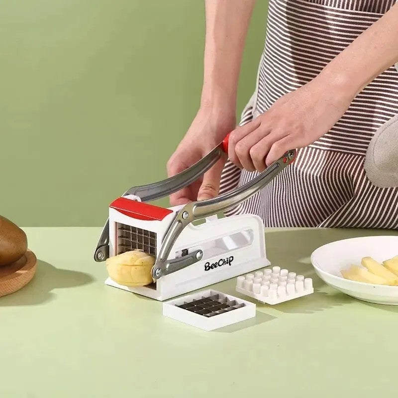 Multicolor manual vegetable cutter in use for slicing small potatoes
