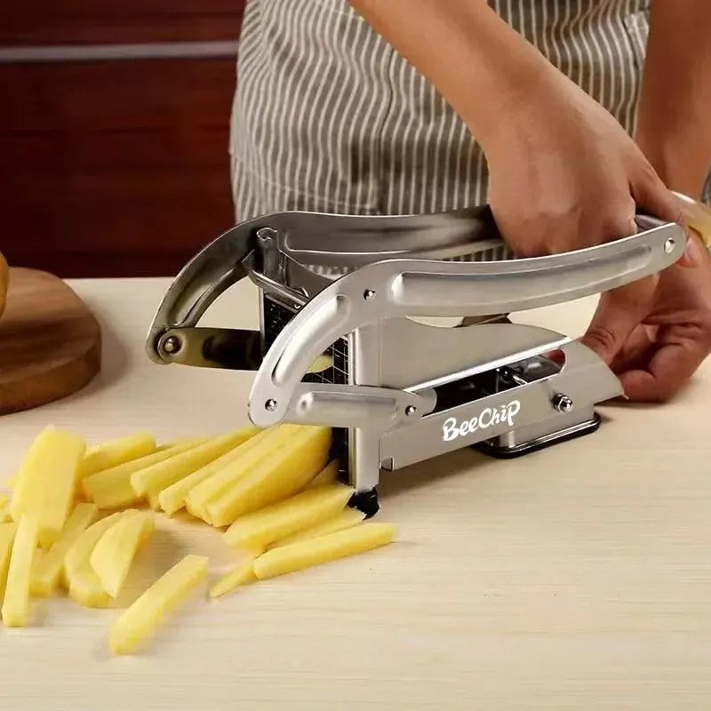 Manual cutter being used to slice potatoes into fries on kitchen counter
